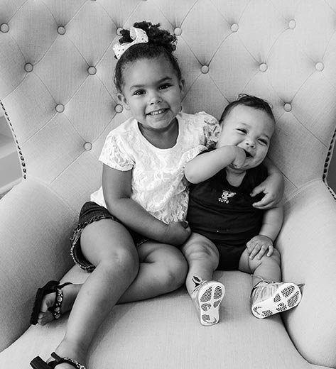 Brother and sister sitting in chair